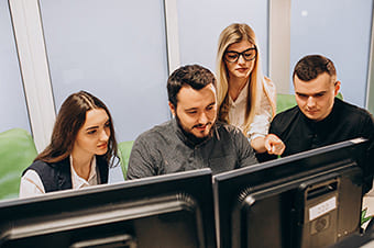 Workers in an IT company working on a computer
